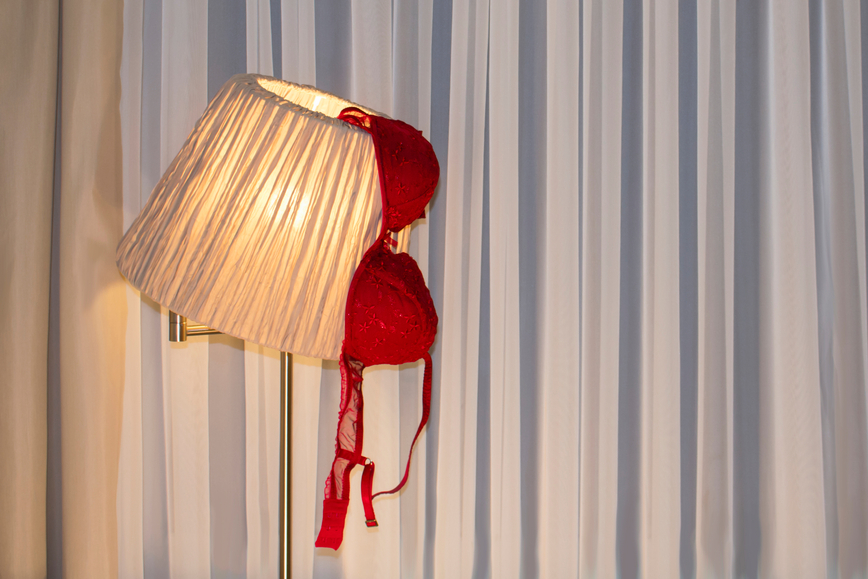 Red,Brassiere,On,The,Floor,Lamp