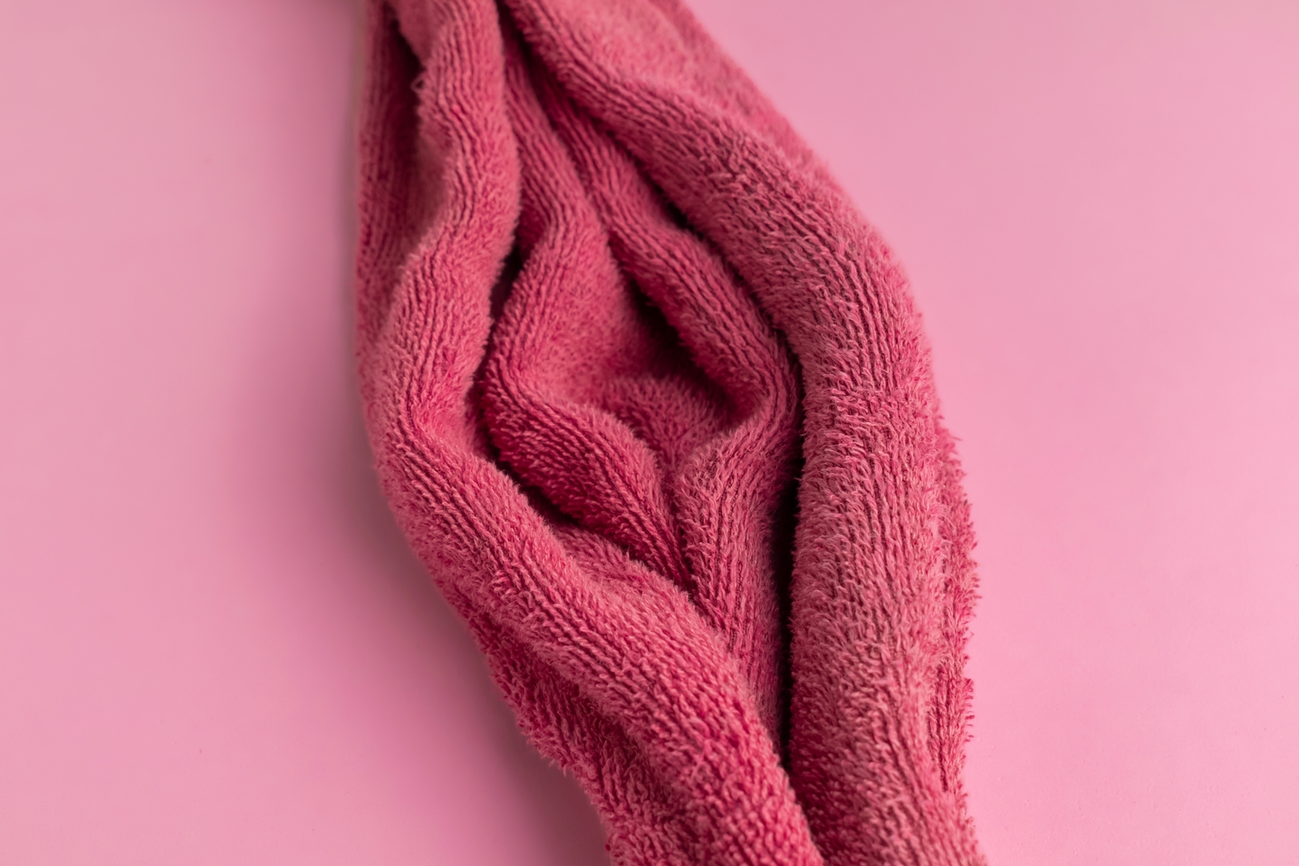 Red,Towel,Fabric,Shaped,As,Woman,Vagina,On,The,Pink